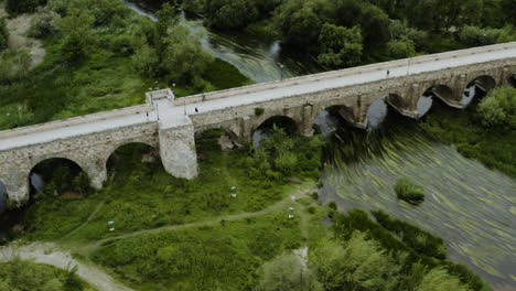 the historic roman bridge over the tormes river and the riverside parks in salamanca, spain