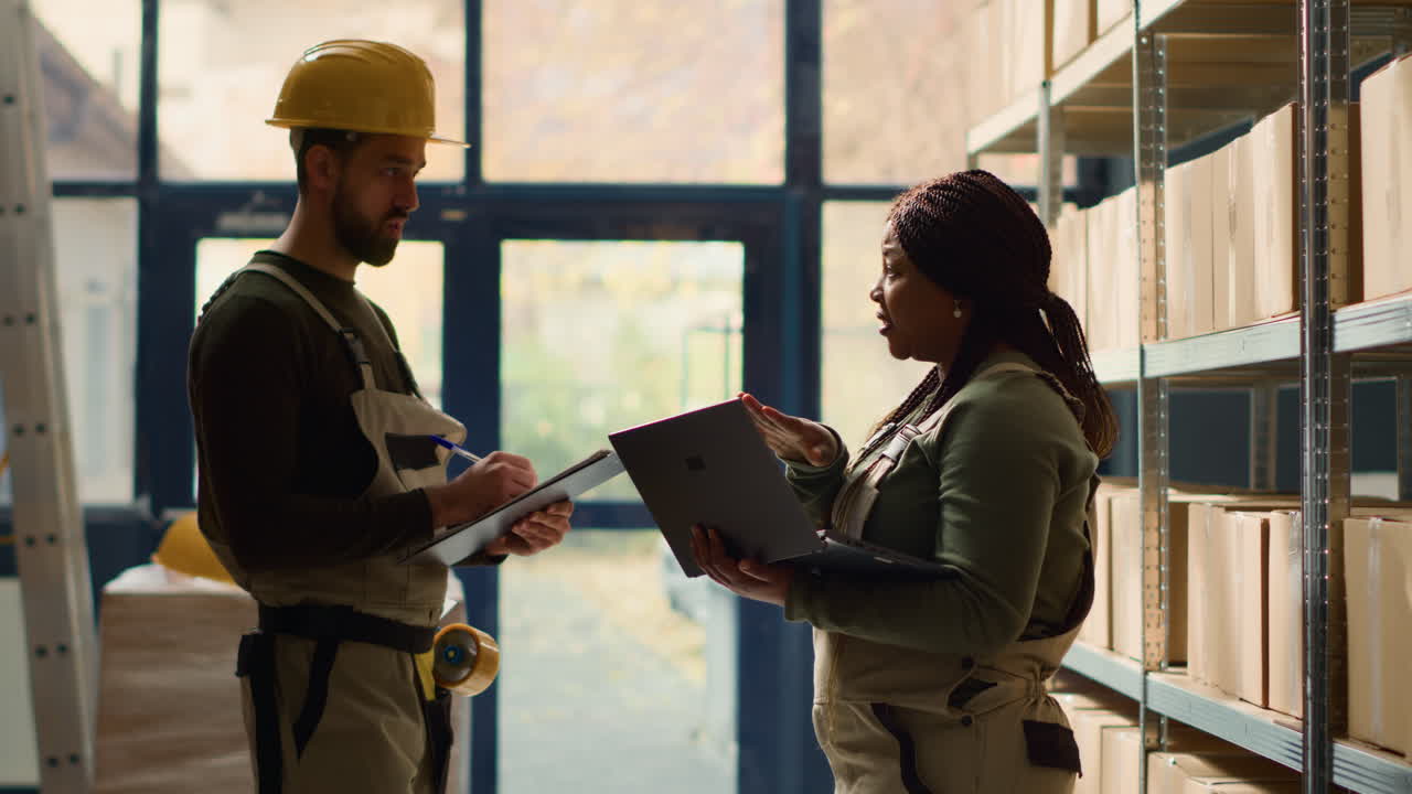 Warehouse workers discussing inventory