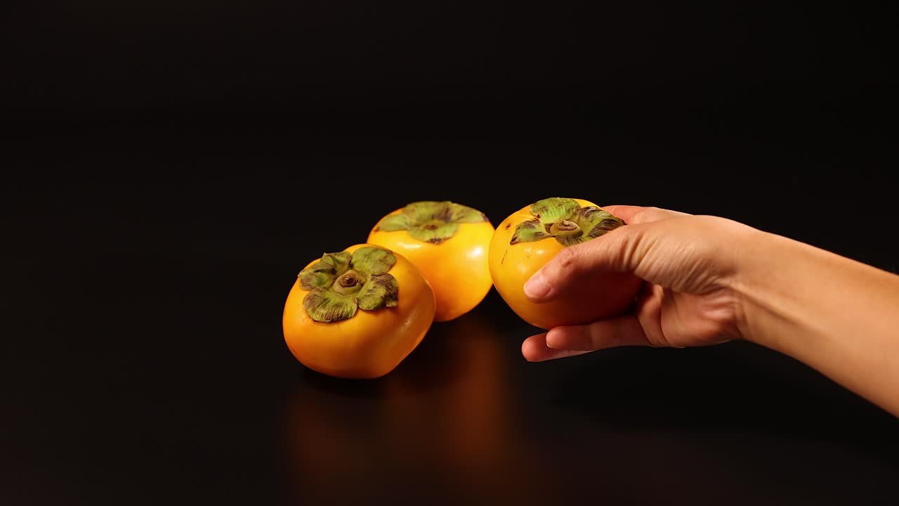 una mano alcanza la fruta del dragón en la mesa