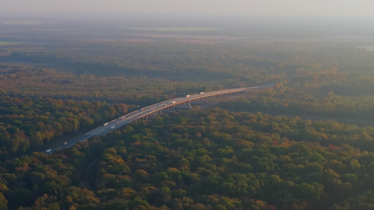 Aerial view of Arkansas interstate over vast green forest, calm and peaceful