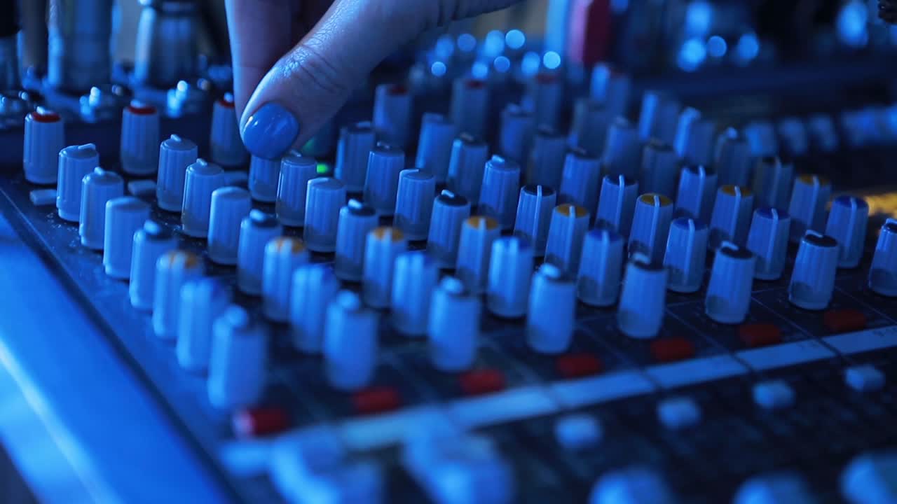Sound Music Mixer Control Panel. Close-up of sound engineer working on music mixer in the recording studio