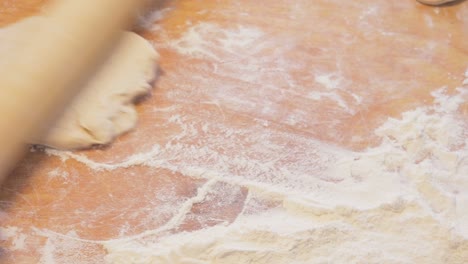woman rolling dough with rolling pin. passing food traditions from old generation to young generation. food preparing