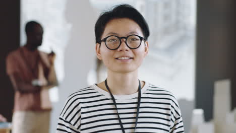 portrait of cheerful asian woman on business conference