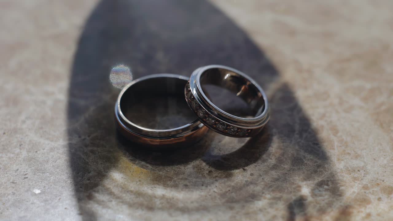 Two golden rings are illuminated by a beautiful iridescent light. Shooting at close range