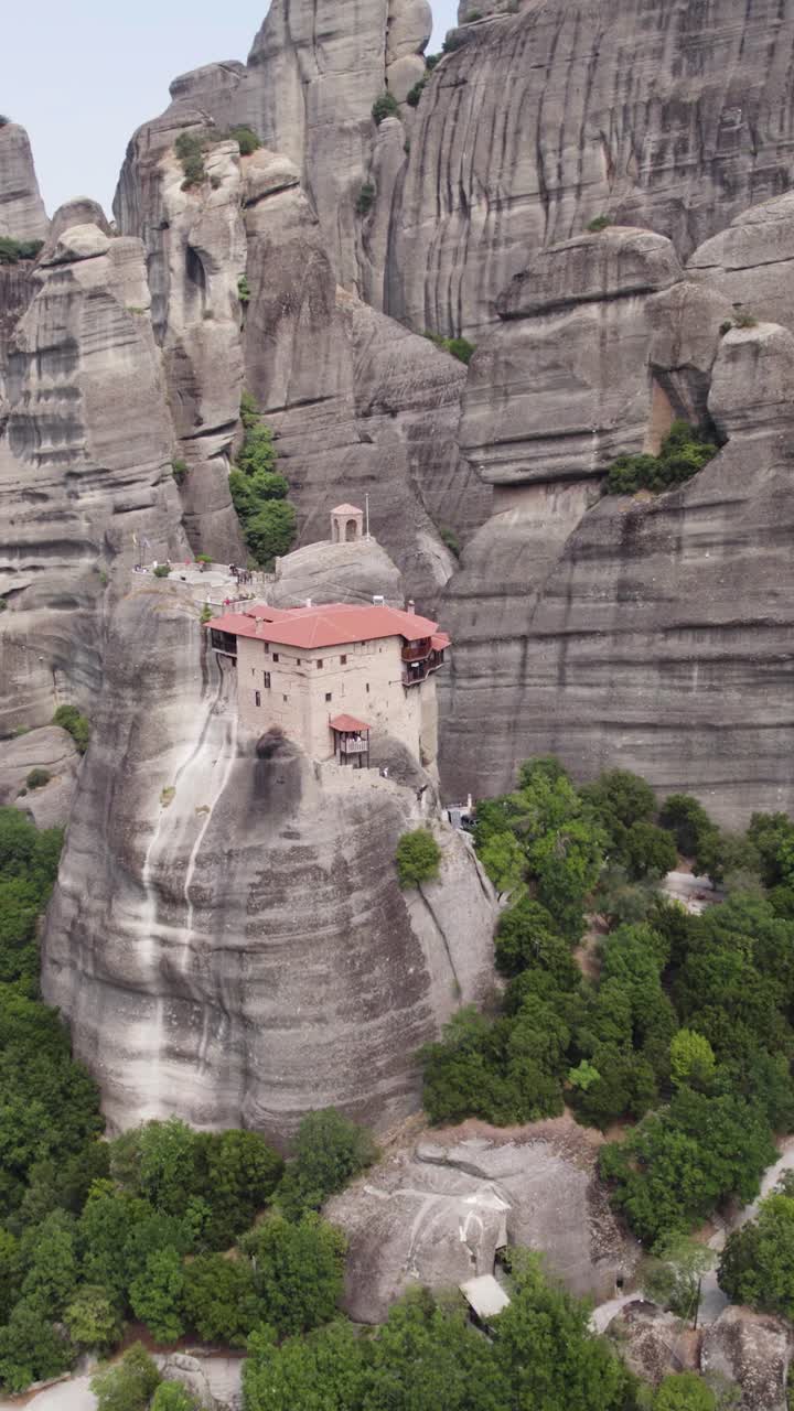 Vertical aerial view of Saint Nicholas of Anapafsas Monastery perched on the cliffs of Meteora in Thessaly, Greece
