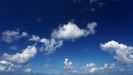 timelaps of white clouds flying over the blue sky towards the camera and over it