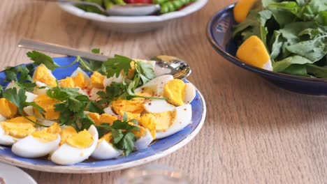 sliced boiled eggs with parsley on a plate