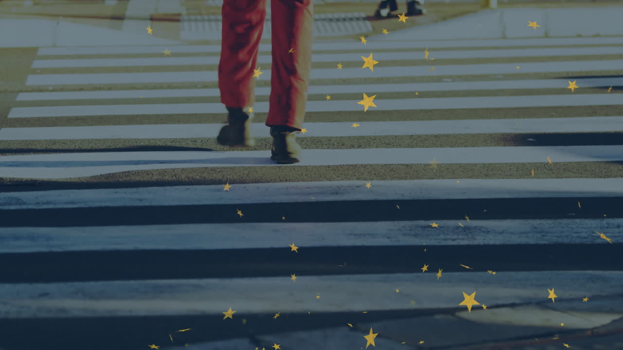Person in red pants crossing street with stars animation overlay