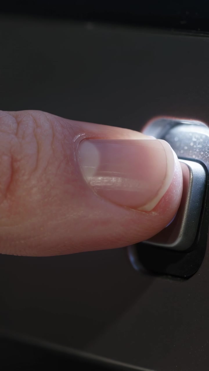 Vertical video: Entering fingertip pressing power button on device panel, turning on, copy space