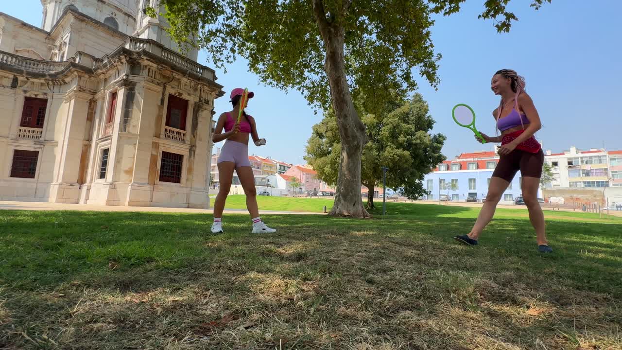 Women playing frisbee in a park