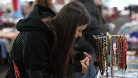 teenager browsing jewelry at a market