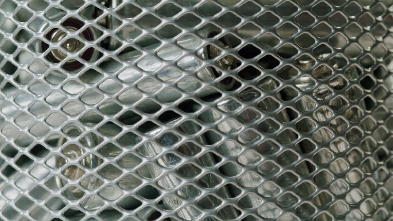 Silver batteries AA and AAA falling into wastebasket close-up. Double-A battery is a standard size single cell cylindrical dry battery. Batteries are common in portable electronic devices. Environmental impacts of lithium-ion batteries concept. An AA battery is composed of a single electrochemical c