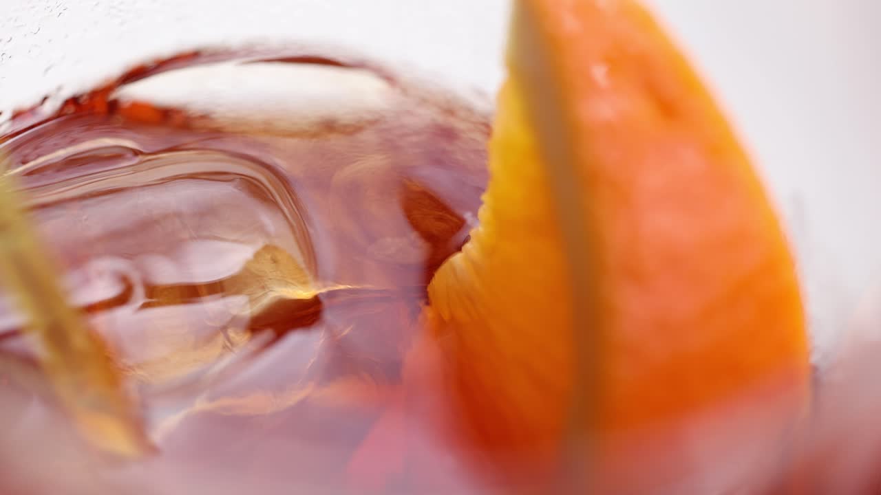 Close-up of an Aperol Spritz cocktail with orange slice, showcasing vibrant colors and refreshing appeal