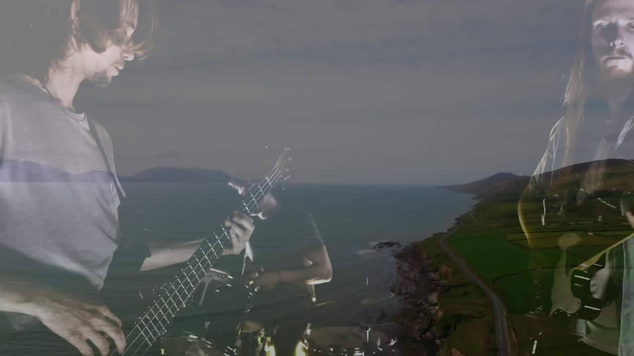 Male musicians playing electric guitars in coastal studio, showing animated technology charts