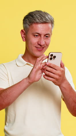 man scrolling smartphone suddenly shocked with wide eyes open mouth surprised by unexpected news