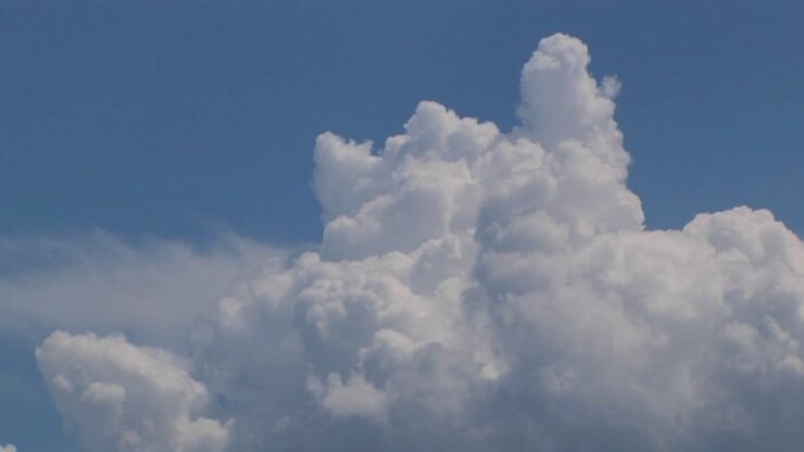 A time lapse of thunderclouds expanding in a blue sky 1