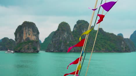 colorful flags moving with the wind in ha long bay