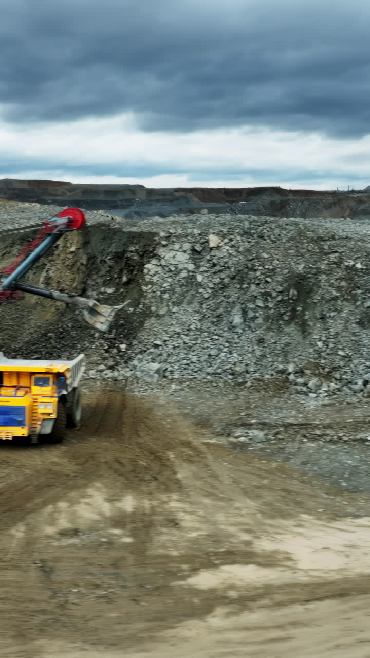 Open Pit Mine Landscape with Piles of Rocks and Overcast Sky