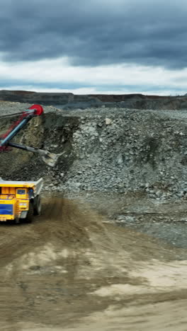open pit mine landscape with piles of rocks and overcast sky