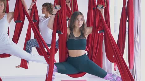 el grupo de mujeres de yoga de mosca moderno se encuentra en la asana del guerrero