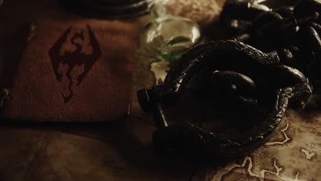 tilt-up shot of a leather viking book with a rune over a table and other viking stuff