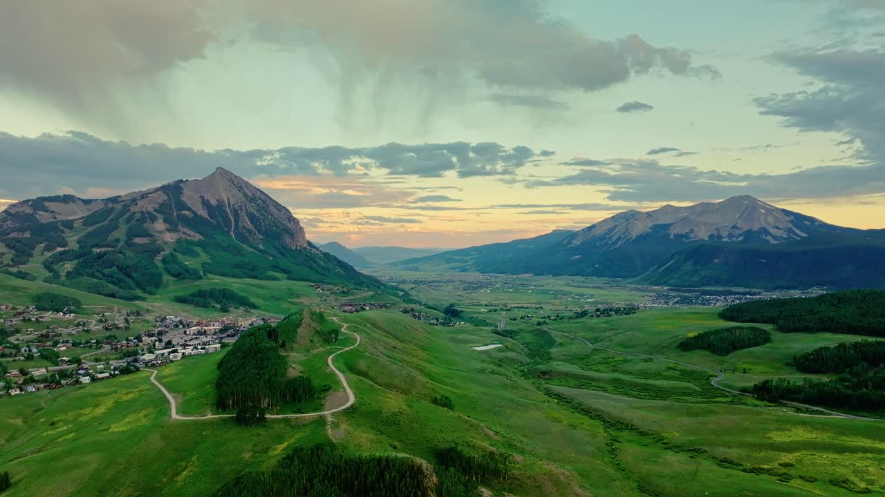 Aerial of the town of Crested Butte and it's lush green valley and mountains, Colorado, USA