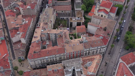 Aerial-drone-shot-over-old-Montpellier-buildings-and-a-tramway