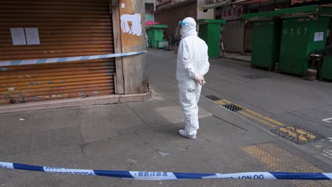 a health worker dressed in a ppe suit is seen standing guarded inside a neighborhood area under lockdown to contain the spread of the coronavirus variant outbreak in hong kong