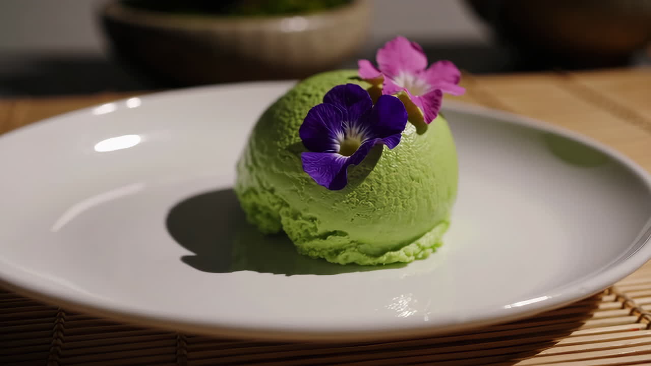 Green Ice Cream Scoop Garnished with Edible Flowers
