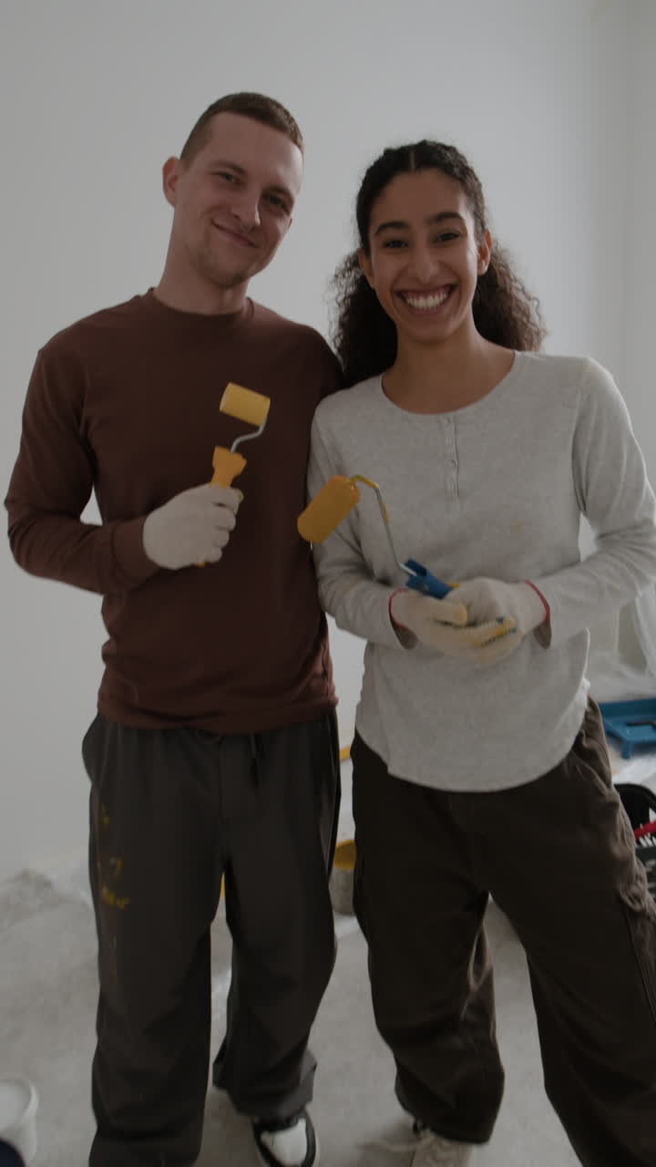 Happy Couple Painting Their Home Together