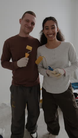 happy couple painting their home together