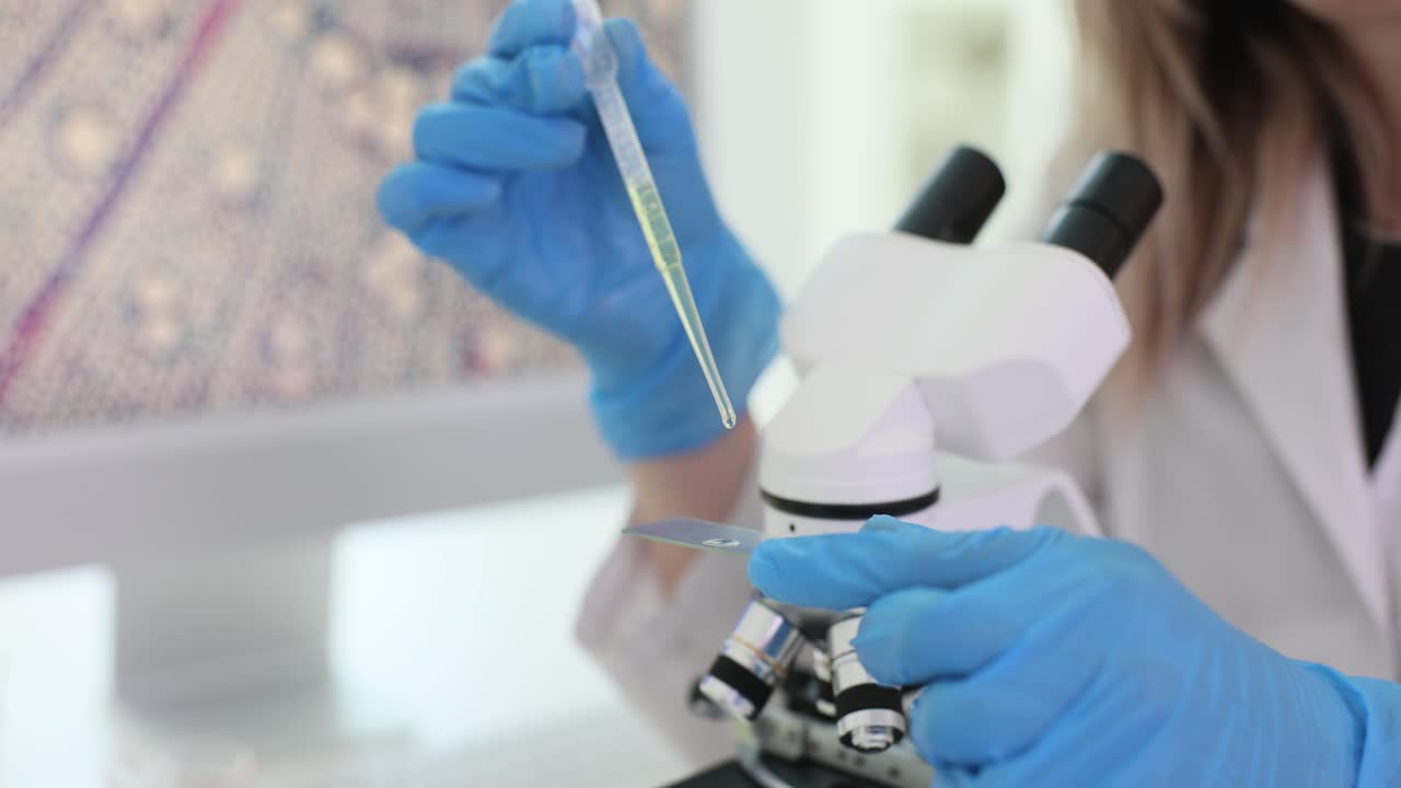Scientist in Blue Gloves Preparing Sample for Microscope