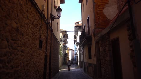 Small-italian-and-spanish-old-looking-brick-alley-walked-by-young-man