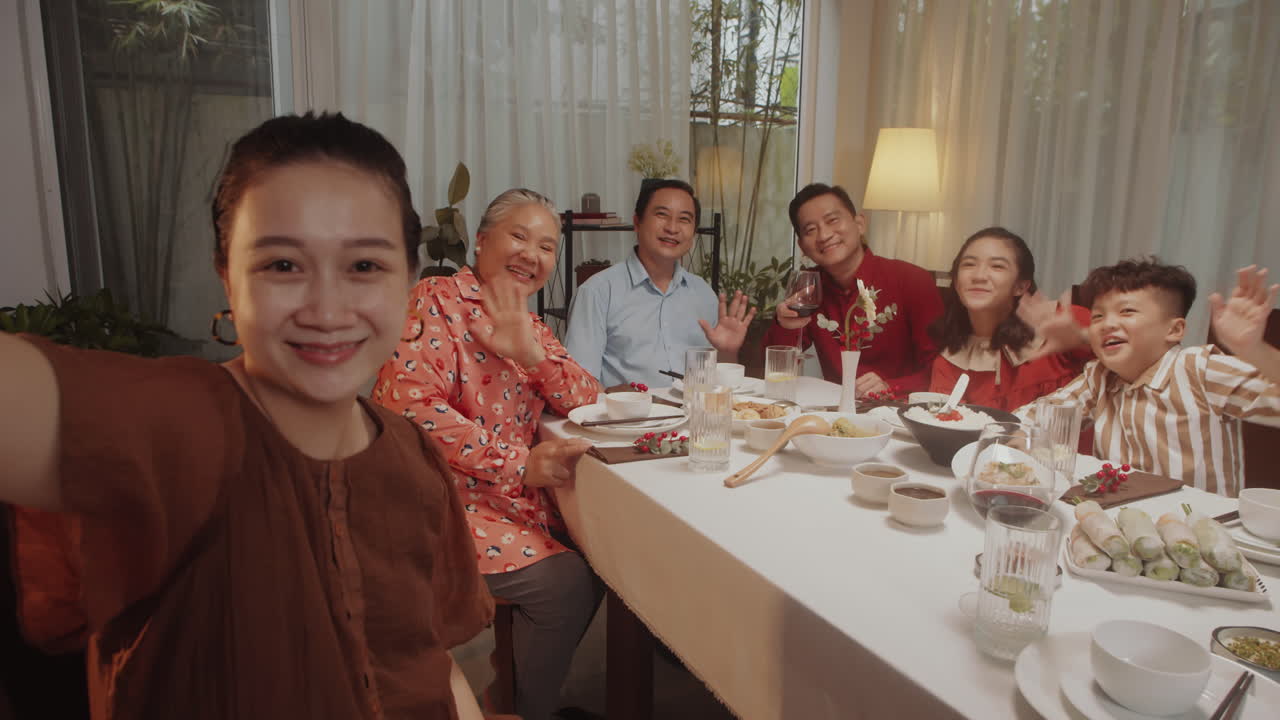 POV of Woman Filming Video with Family during Dinner
