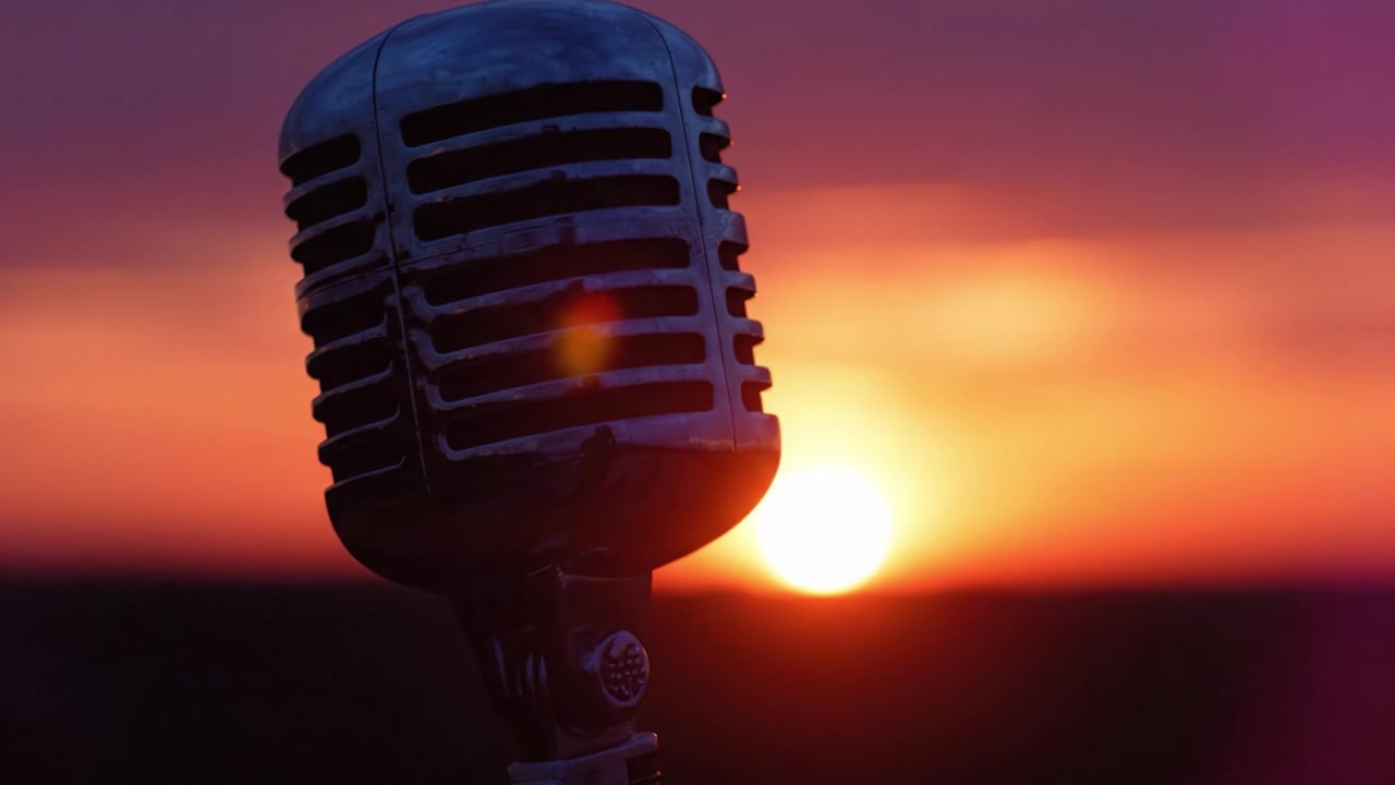 Classic Microphone Silhouette Against a Stunning Sunset Sky: Capturing the Essence of Music and Performance in a Beautiful Evening Setting