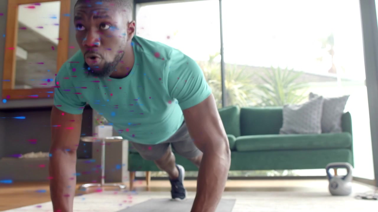 Man doing pushups on mat starting fitness workout phone artifacts appearing over him keeping form