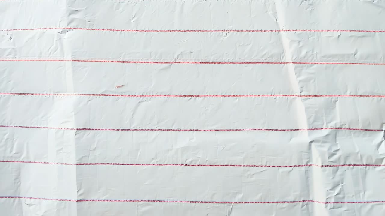 Aerial view of crumpled lined paper, capturing texture and shadows