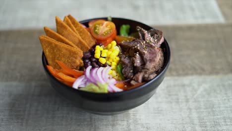 bowl of food with tortillas, corn, meat, chiledulce, beans, tomatoes, lunch