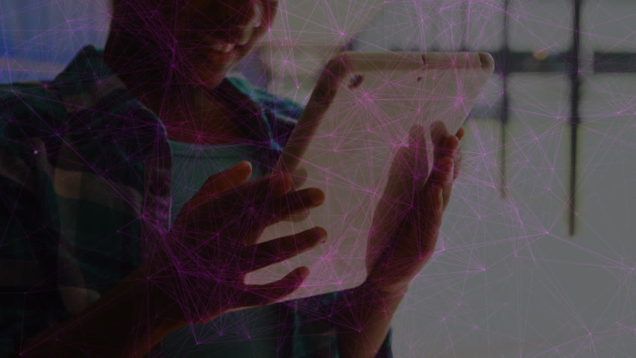 Animation of network of connections over mid section of african american boy using digital tablet