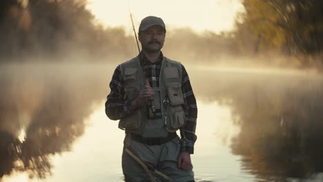 fisherman in misty morning river