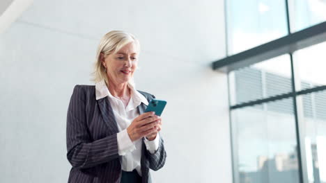 businesswoman using smartphone in modern office