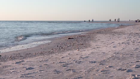 the beauty of the ocean waves rolling over the sandy beach on a sunny day