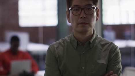 Portrait-of-asian-businessman-in-meeting-room-looking-to-camera-smiling