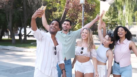 cheerful diverse friends taking self-portrait on city street