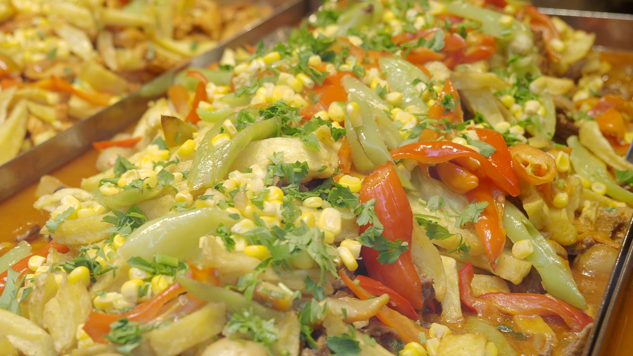 Vibrant Cooked Vegetable Dish with Potatoes, Corn, and Bell Peppers