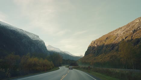driving on norwegian roads with beautiful moutain landscape