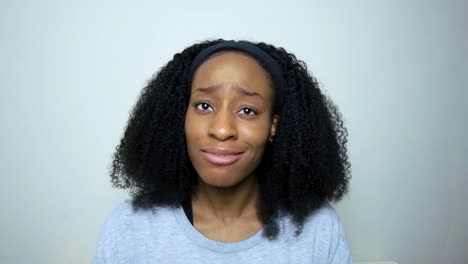 young student listening intently whilst looking directly toward camera