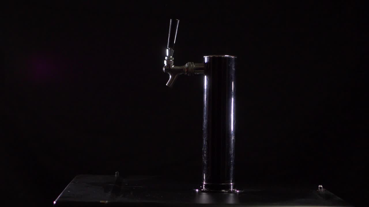 Bartender pours beer into glass
