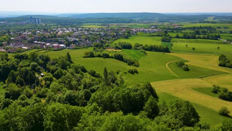 4k aerial drone video of the village and farmland below the historic bamberg castle on the edge of bamberg, germany on a beautiful spring day