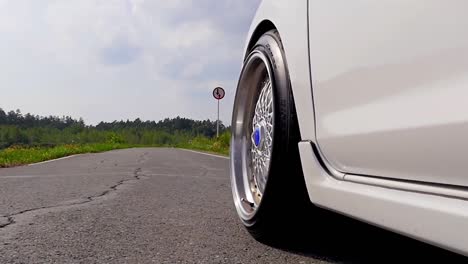 white car on the road with a woman's foot